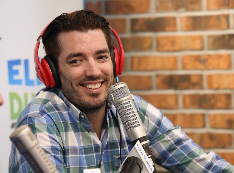 Jonathan Scott wearing a red pair of headphones and speaking into a microphone
