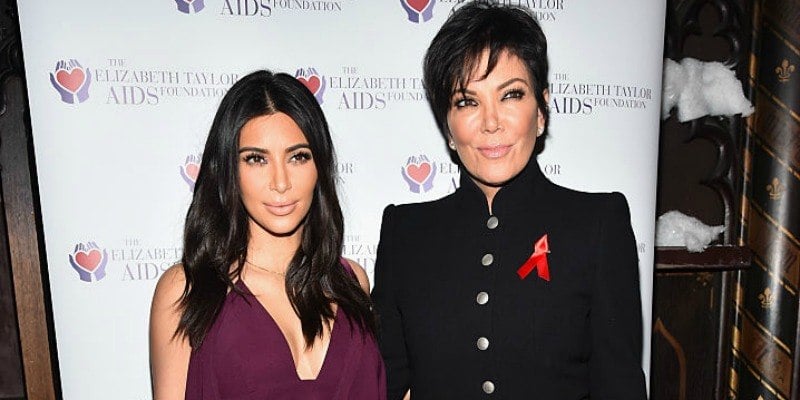 Kim Kardashian and Kris Jenner pose together on the red carpet.