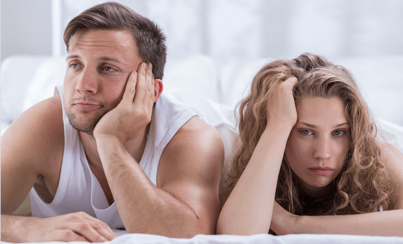 couple looking bored in bed