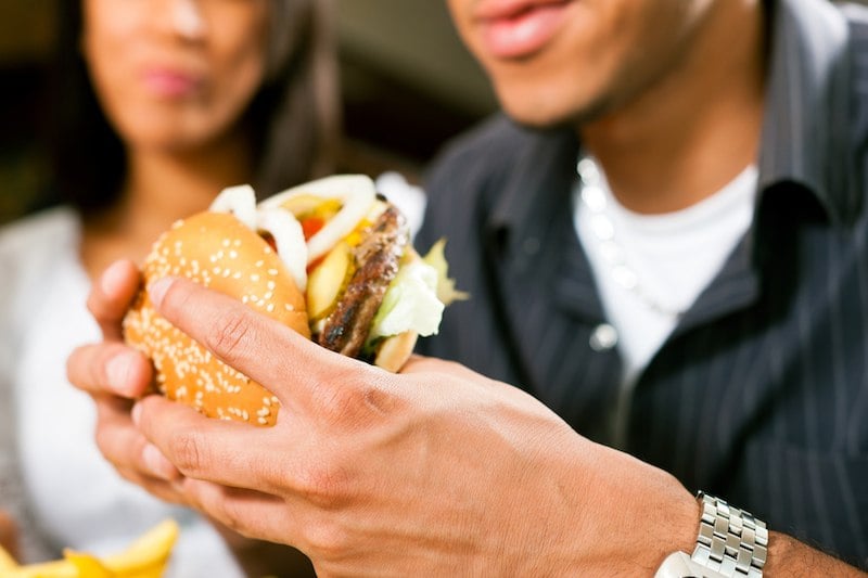 man eating a hamburger man eating a hamburger