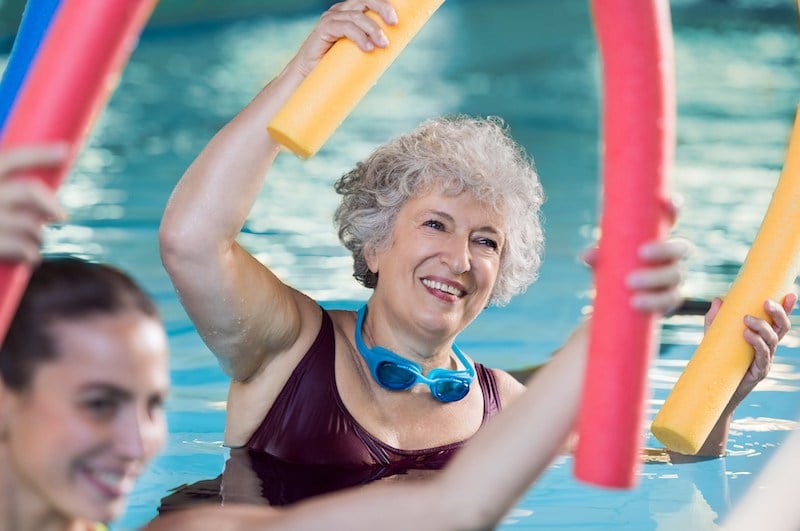 Senior women doing exercises in the pool Senior women doing exercises in the pool