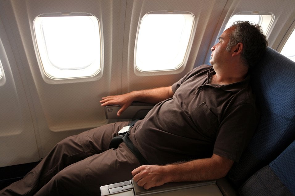 Passenger looking through window in the airplane