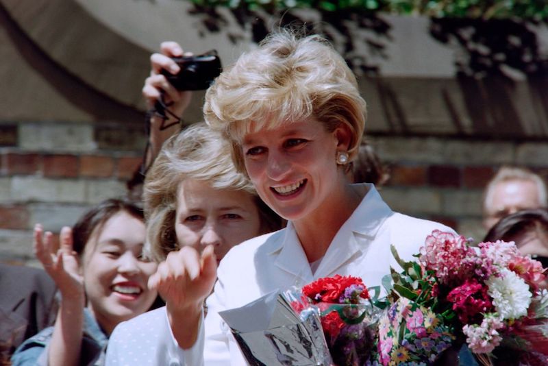 Princess Diana holding a bouquet of flowers. 