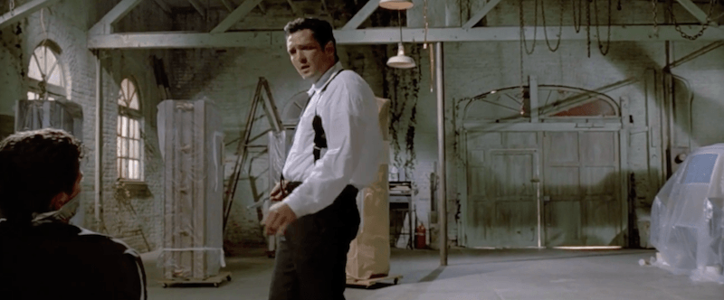 A man stands in an torture chamber in Reservoir Dogs A man stands in an torture chamber in Reservoir Dogs
