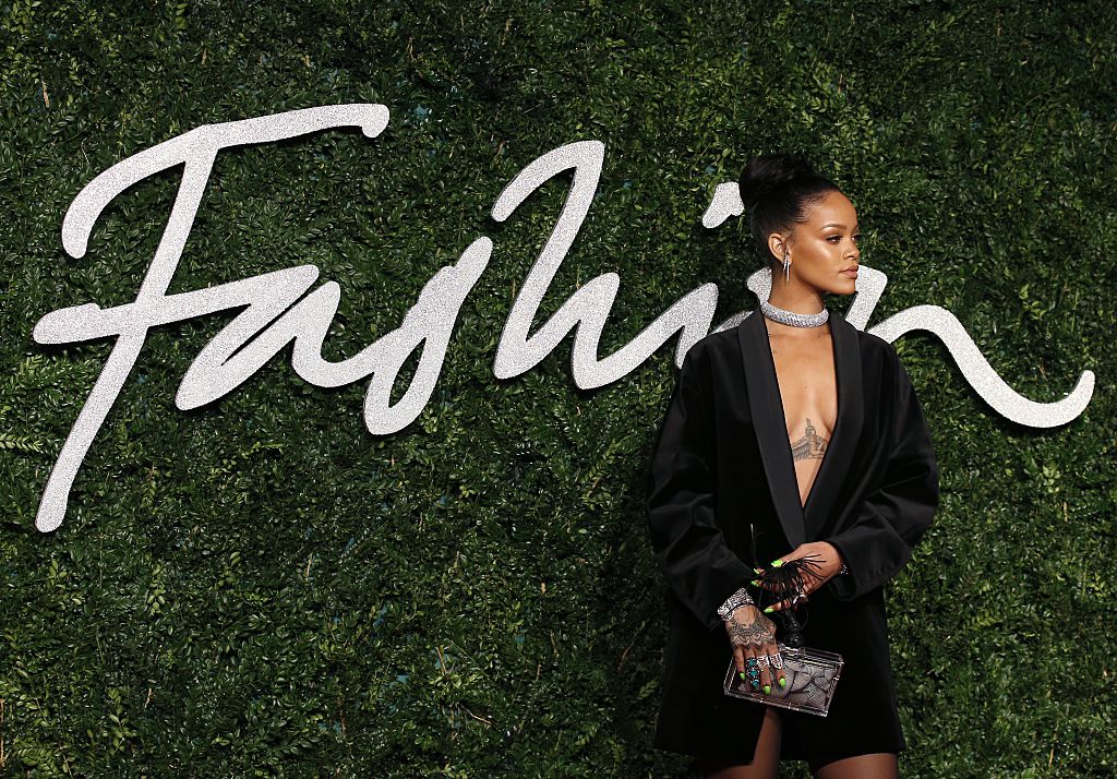 Rihanna posing for photos in a black dress and diamond choker at the 2014 British Fashion Awards. Rihanna posing for photos in a black dress and diamond choker at the 2014 British Fashion Awards.