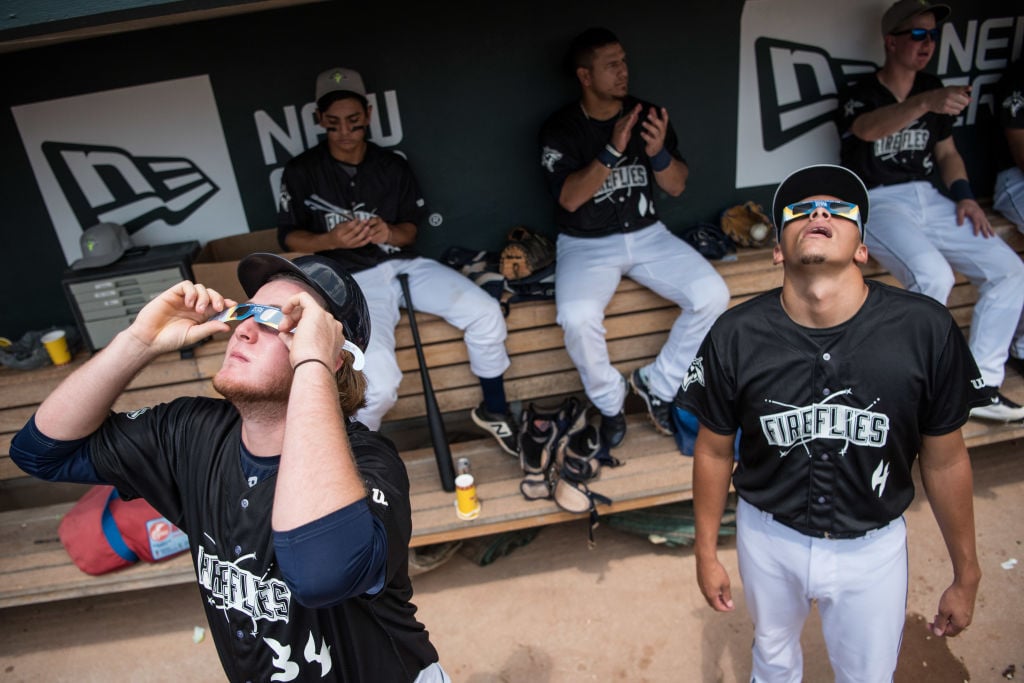 Baseball players watch eclipse