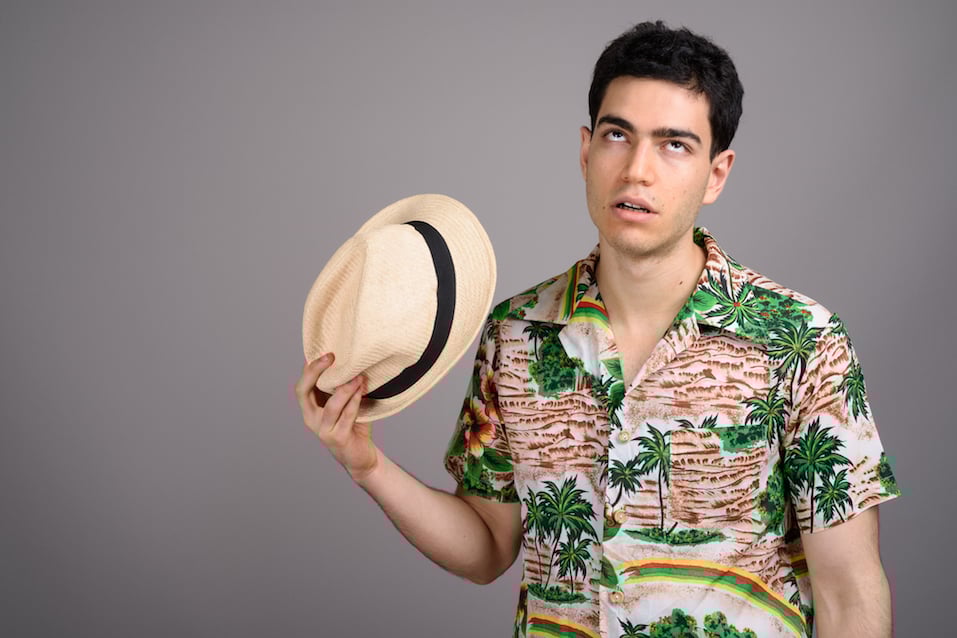 Studio shot of young handsome tourist man
