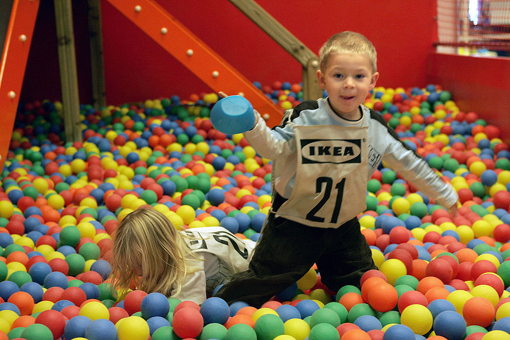 Two children mplays after they have been dropped by their parents at the entry to the Ikea store
