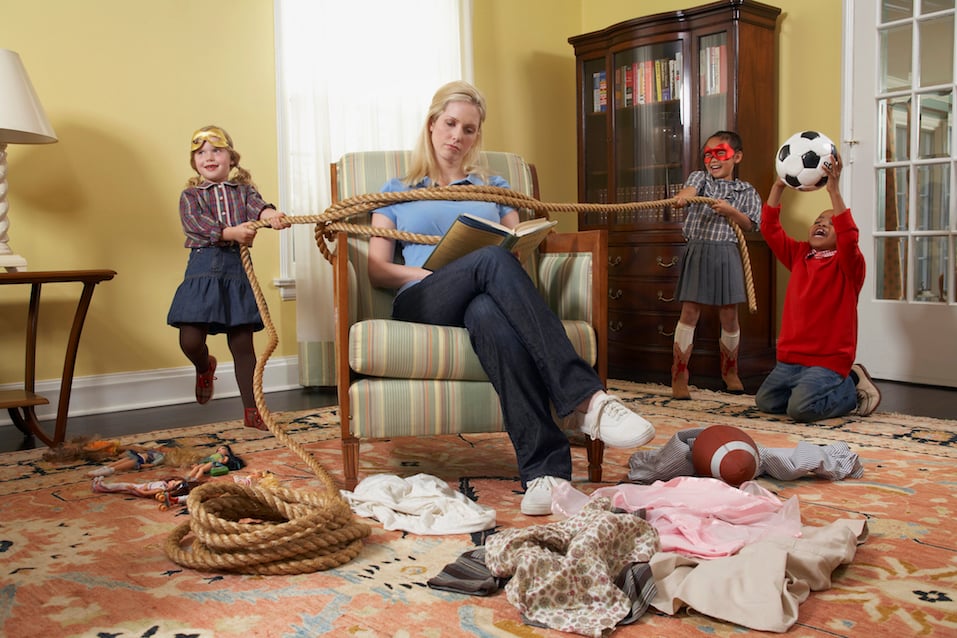 Three children (5-7 years) tying mother with rope in living room