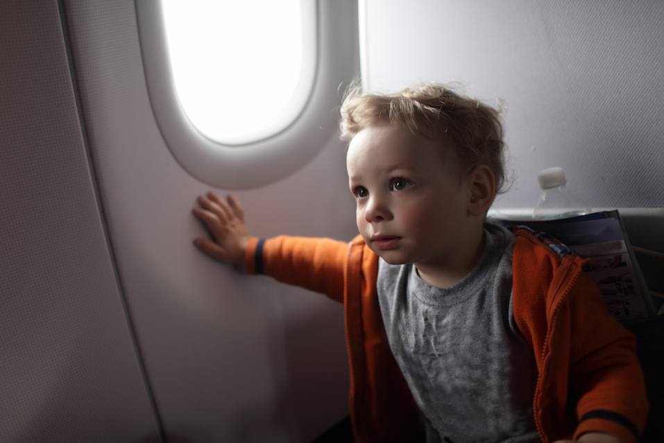 Toddler is on the flight at an airplane