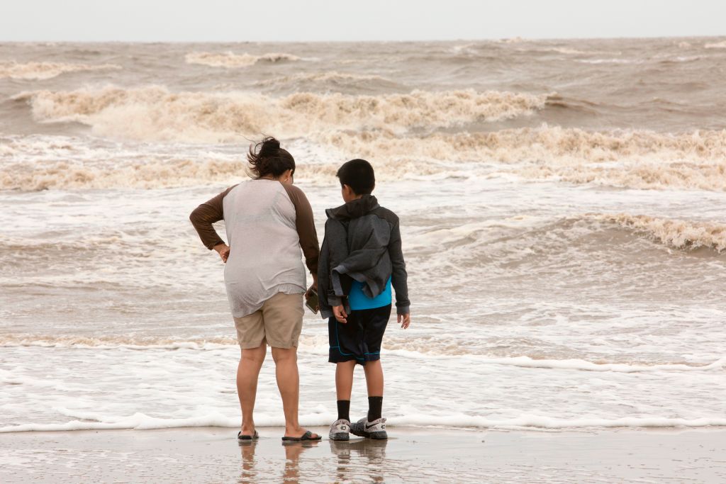 Mom and son watch the surf
