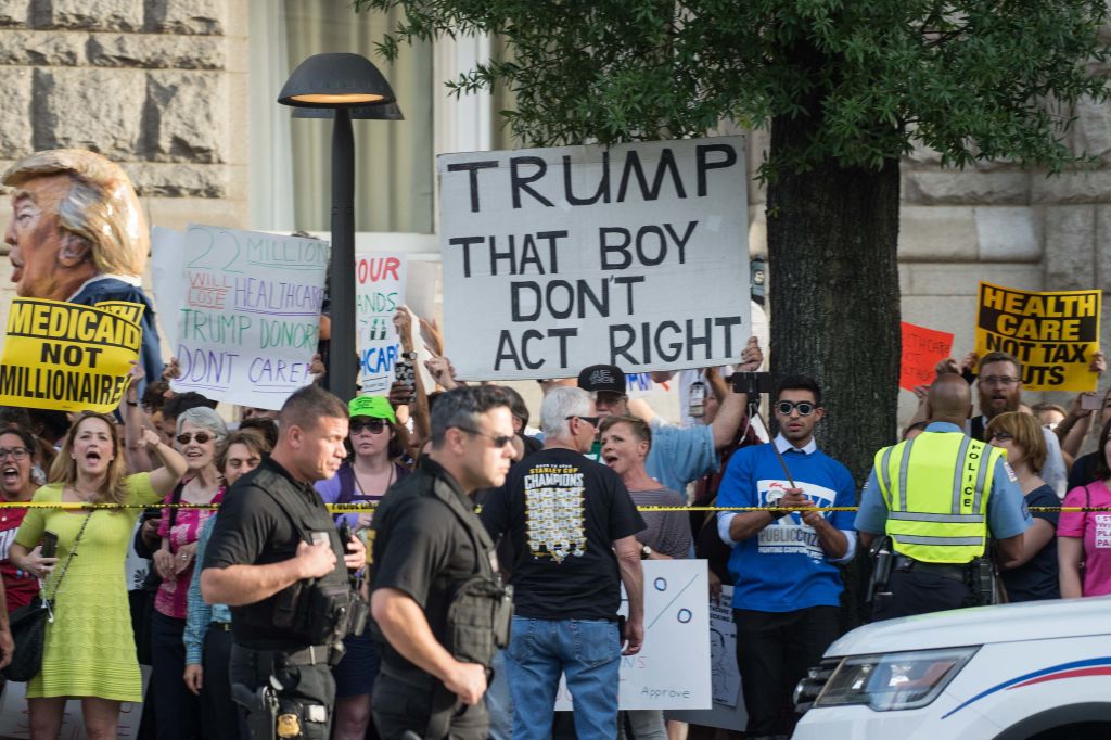 protesters hold up signs against donald trump protesters hold up signs against donald trump
