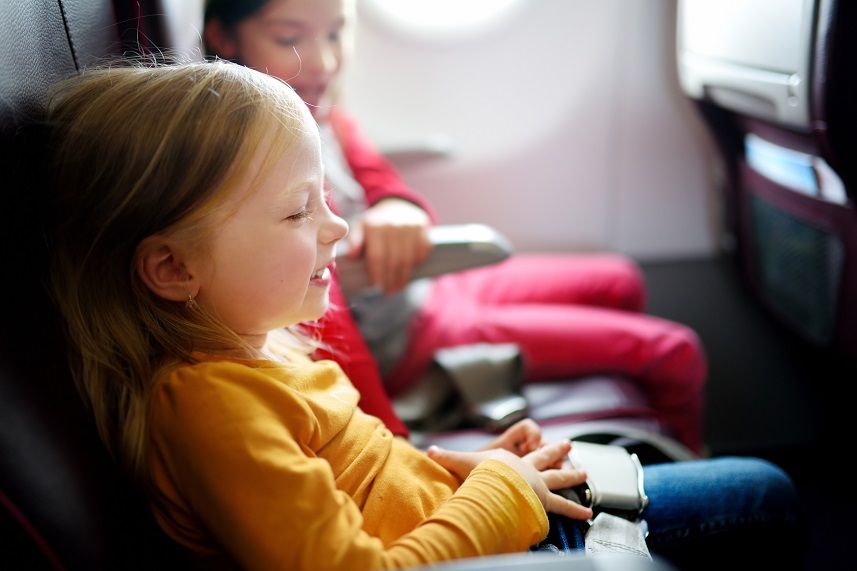 little girls traveling by an airplane