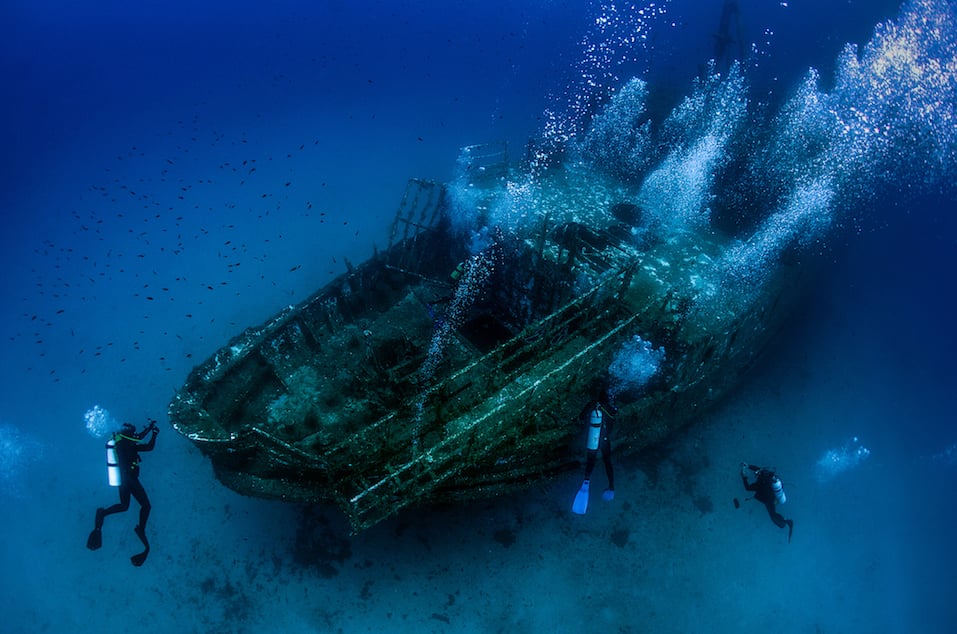 Underwater wreck with divers exploring