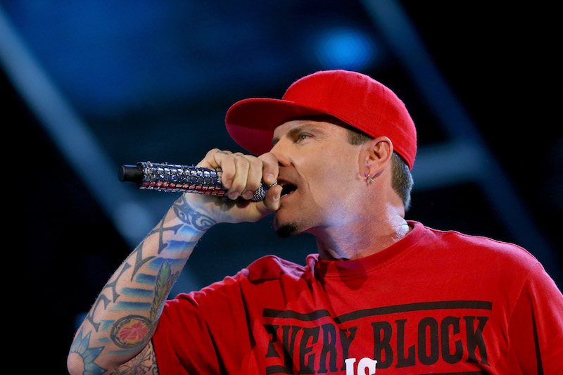 Vanilla Ice holds a microphone during a performance.