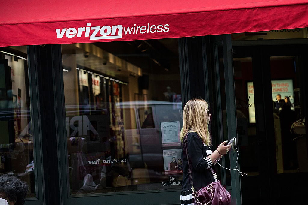 Woman walks past Verizon store