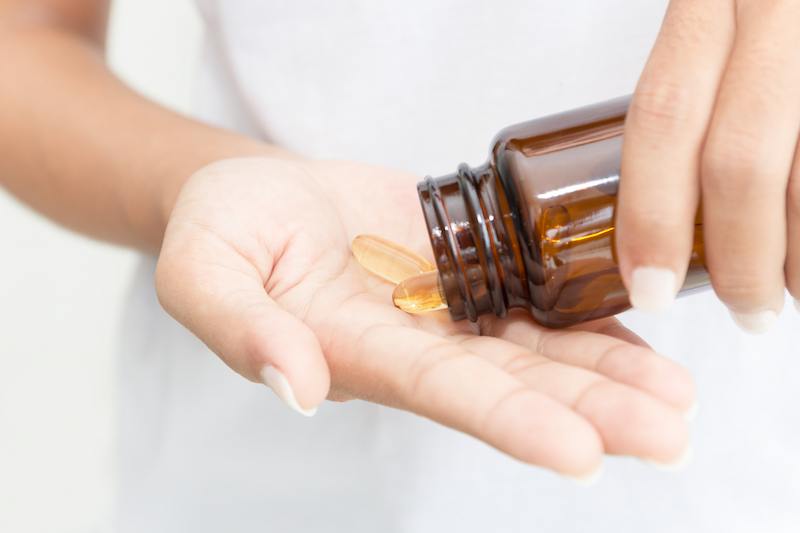 woman taking a vitamin woman taking a vitamin