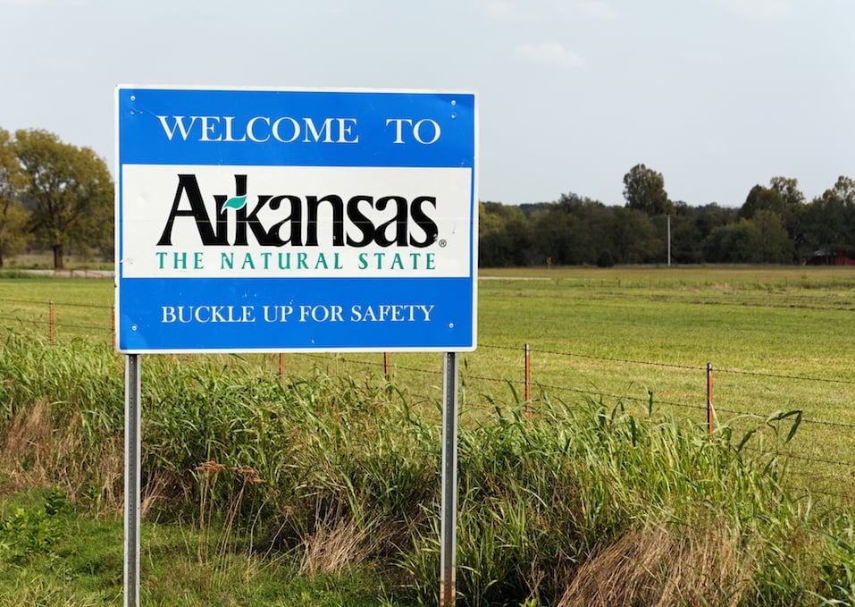 A welcome sign marks the state line between Arkansas and Oklahoma