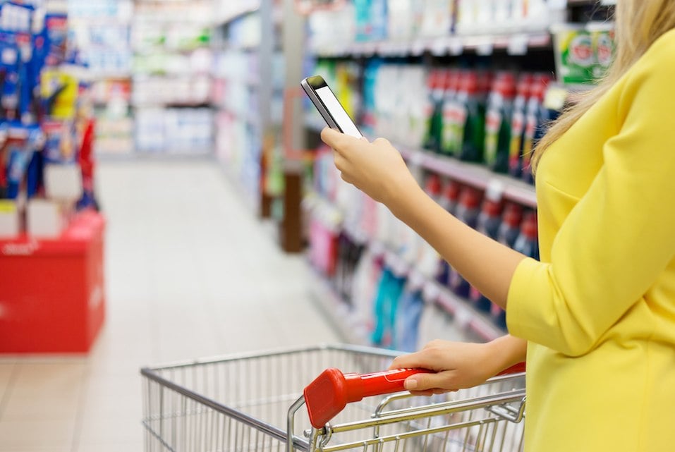 Woman checking shopping list on her smartphone