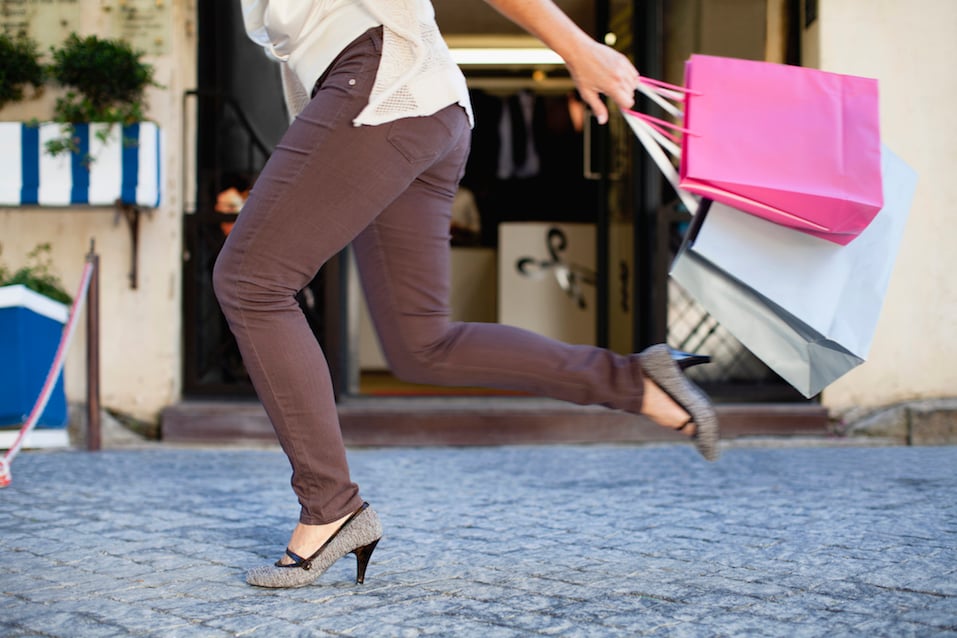 Woman running with shopping bags