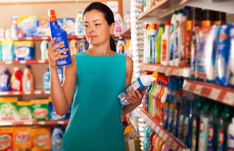 woman choosing cleaning products in a store