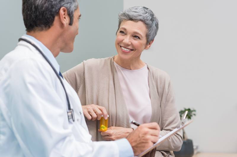 A doctor consults a senior female patient.