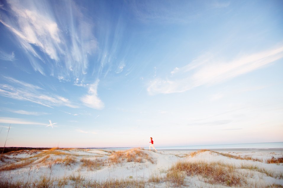 Young healthy man running on the beach