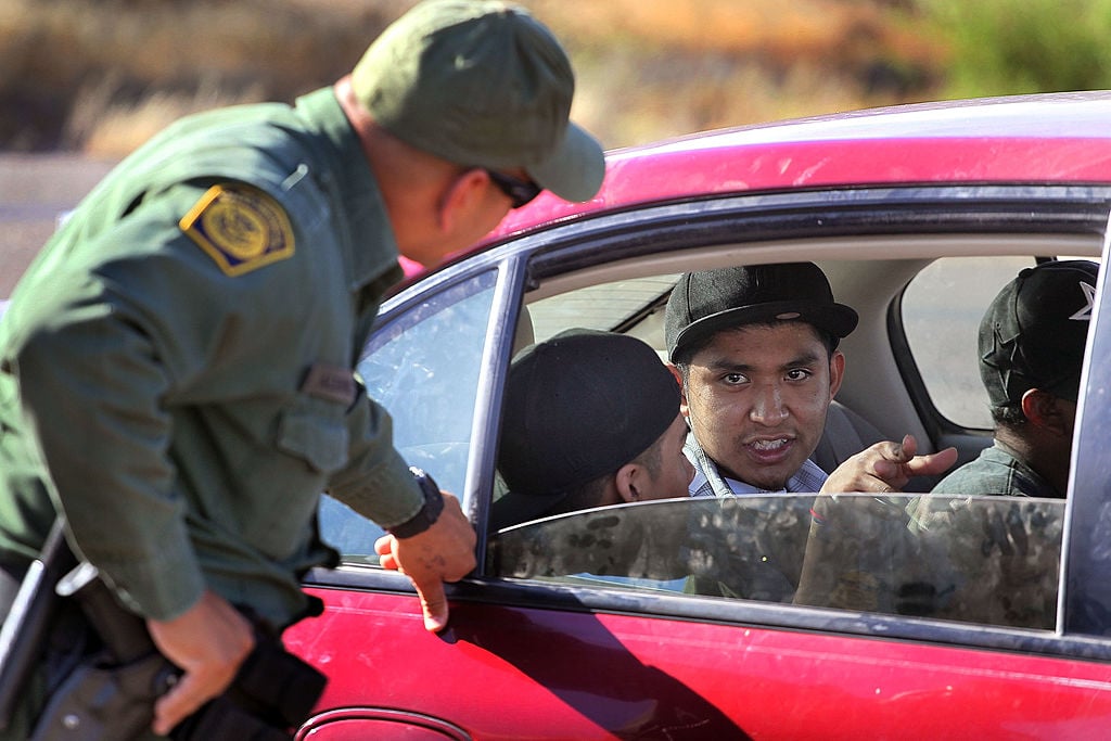 A Border Patrol agent checks vehicles for illegal immigrants and contraband