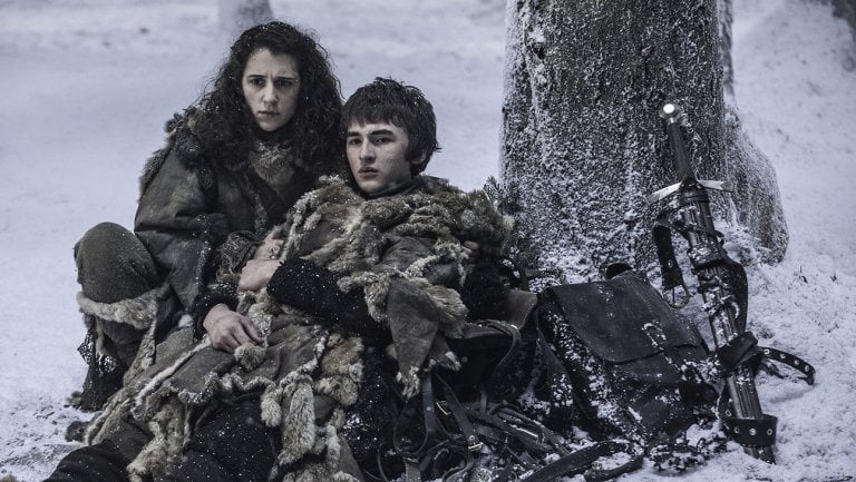 Bran Stark and Meera sit next to a tree in a snowy field in Game of Thrones Bran Stark and Meera sit next to a tree in a snowy field in Game of Thrones