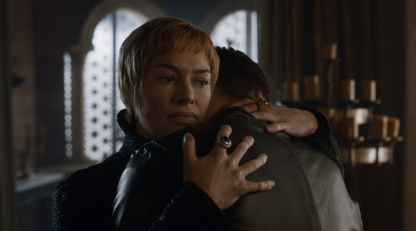 In the Season 7 episode 'Eastwatch,' Cersei, wearing all black, hugs Jaime while looking stern.