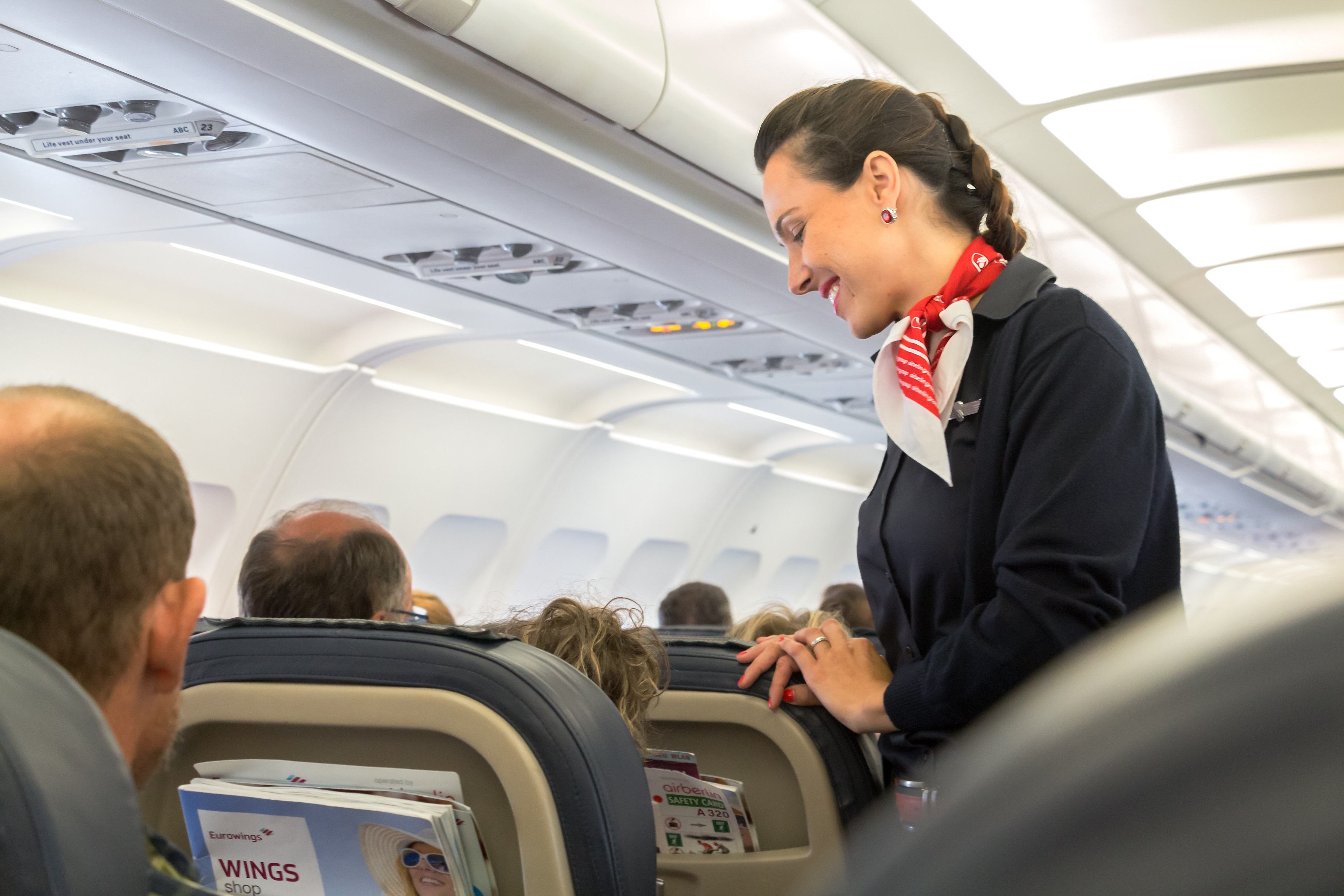 Stewardess talking to passenger