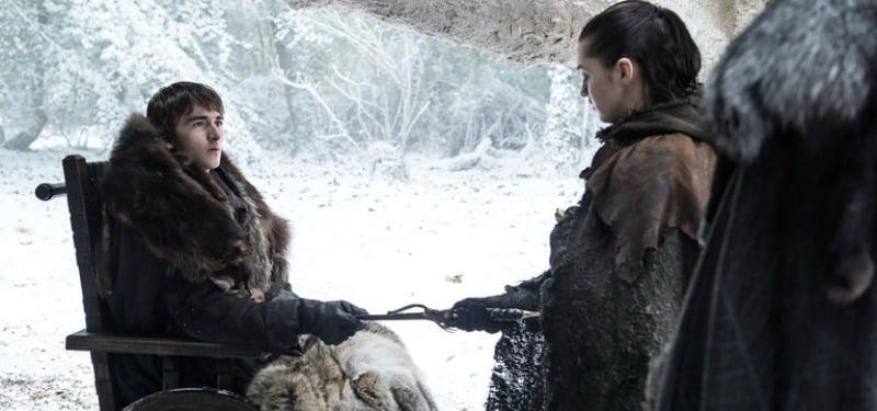 Bran is in a chair handing Arya a dagger as they're outside in the snow. Bran is in a chair handing Arya a dagger as they're outside in the snow.