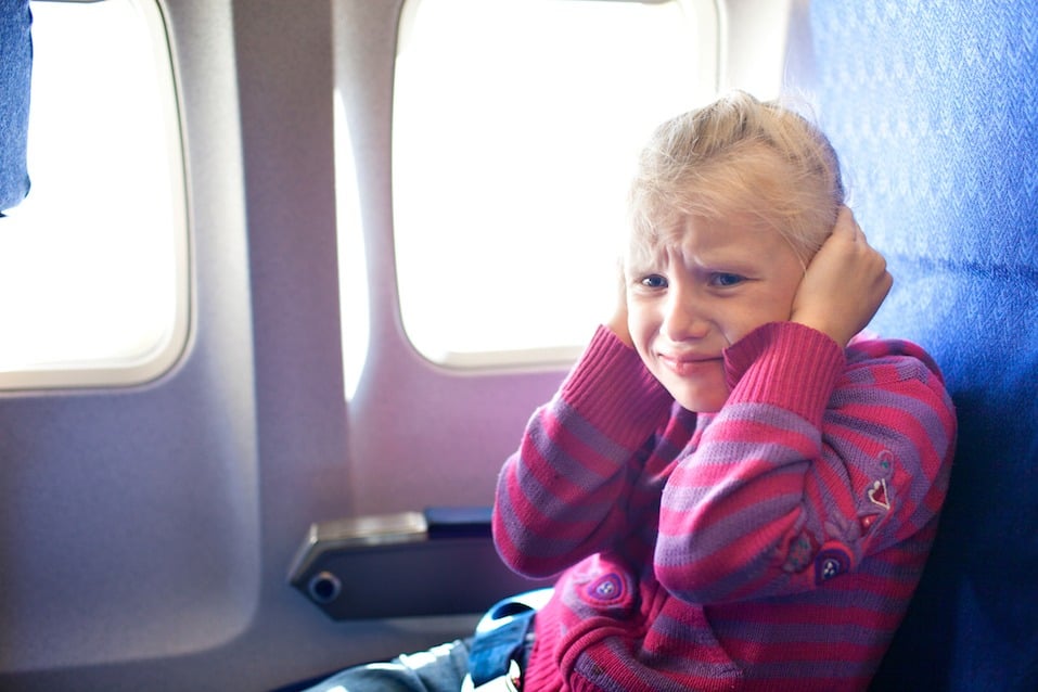 girl closing ears in the airplane girl closing ears in the airplane