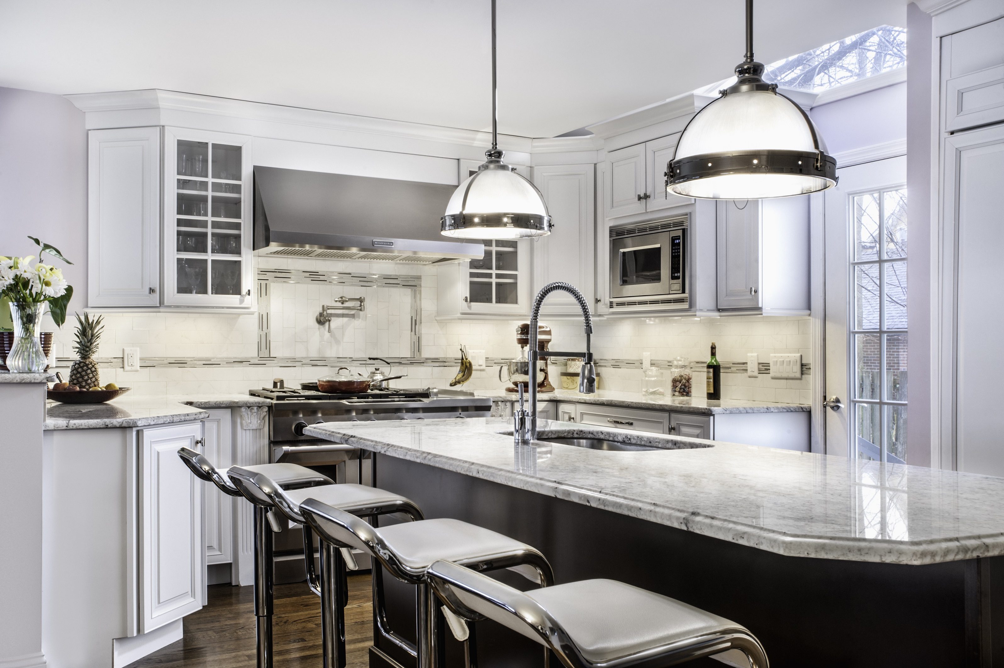 Kitchen with pendant lighting and stools