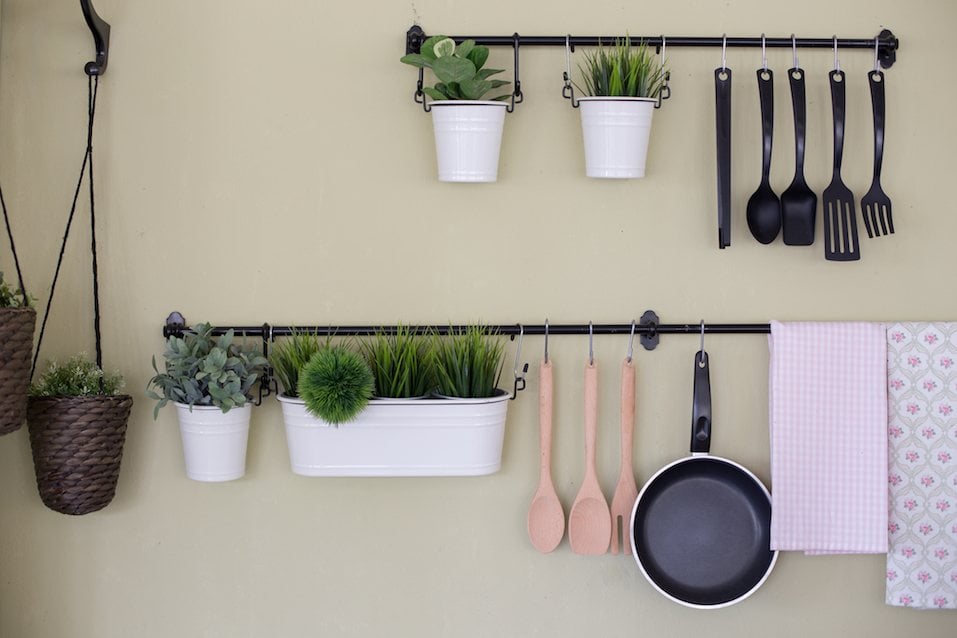 Kitchenware and tree hanging on the wall.