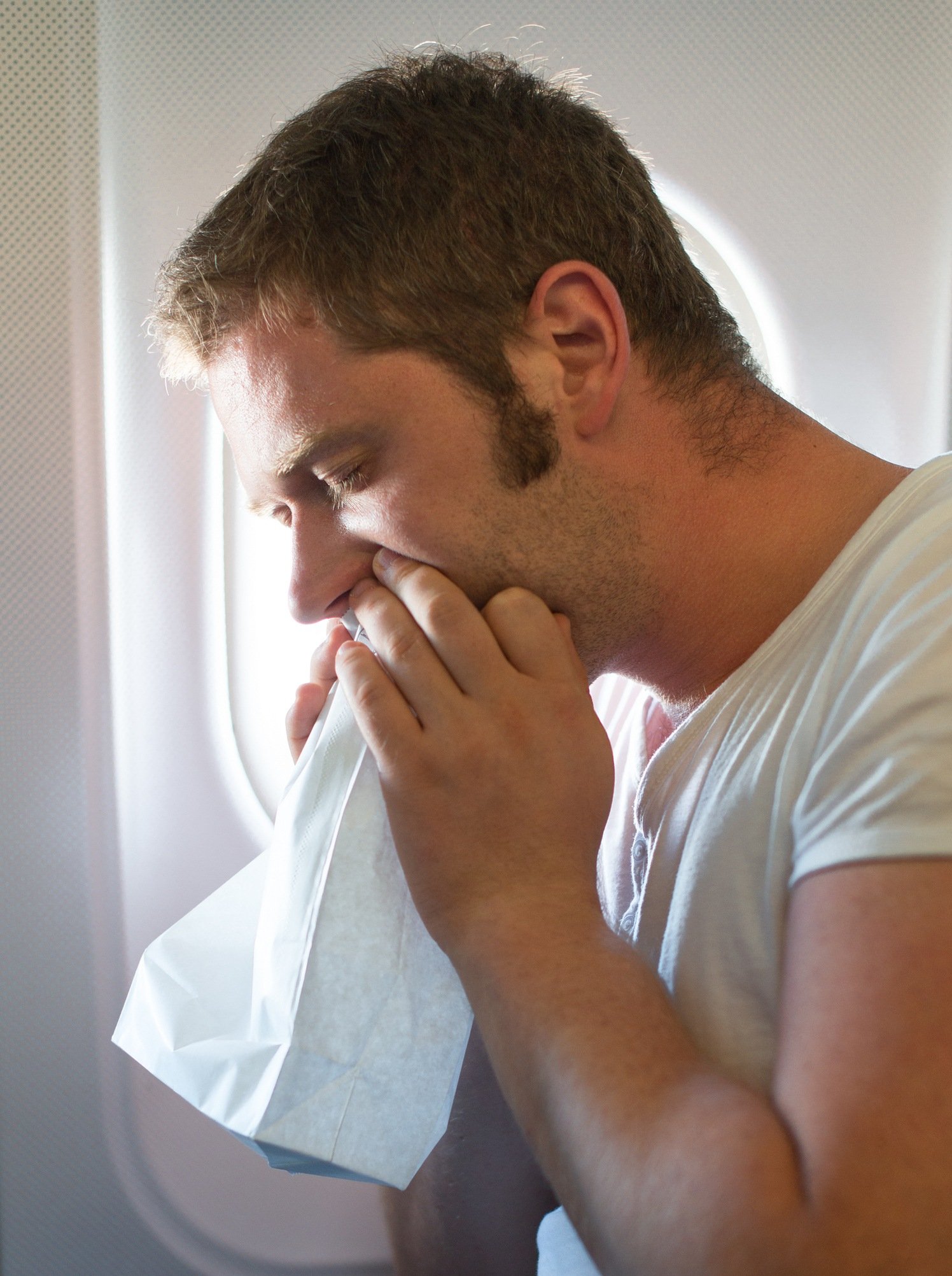 Man throwing up on an airplane