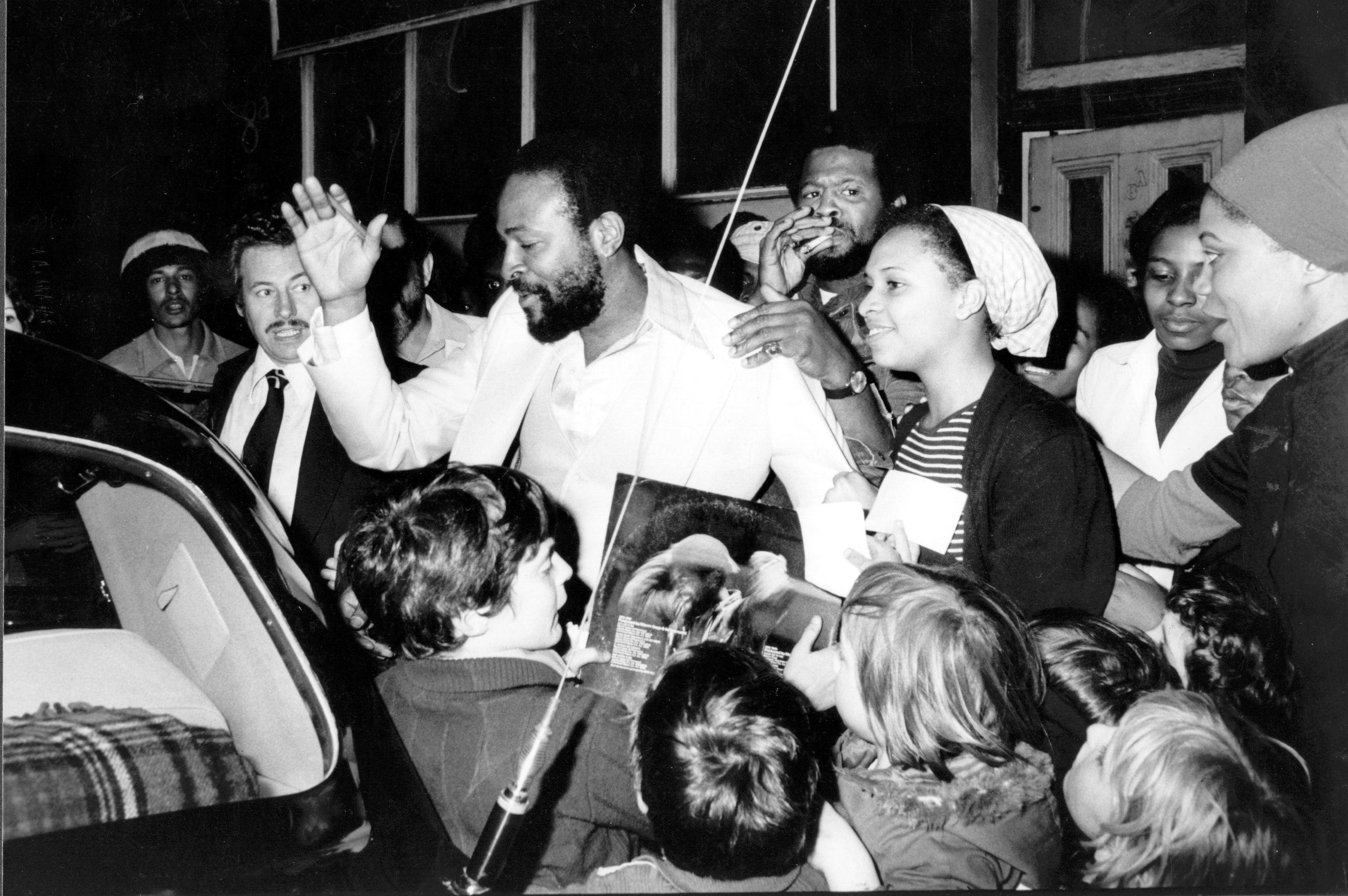 Marvin Gaye gets mobbed by fans while entering a car in London in 1976.