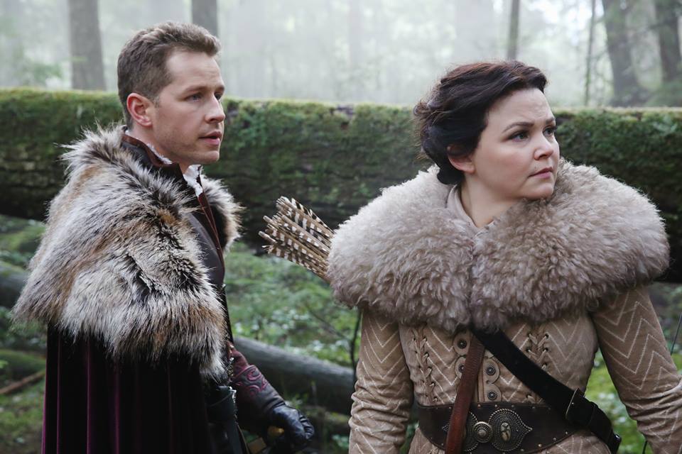 Prince Charming and Snow White stand together and look to the side