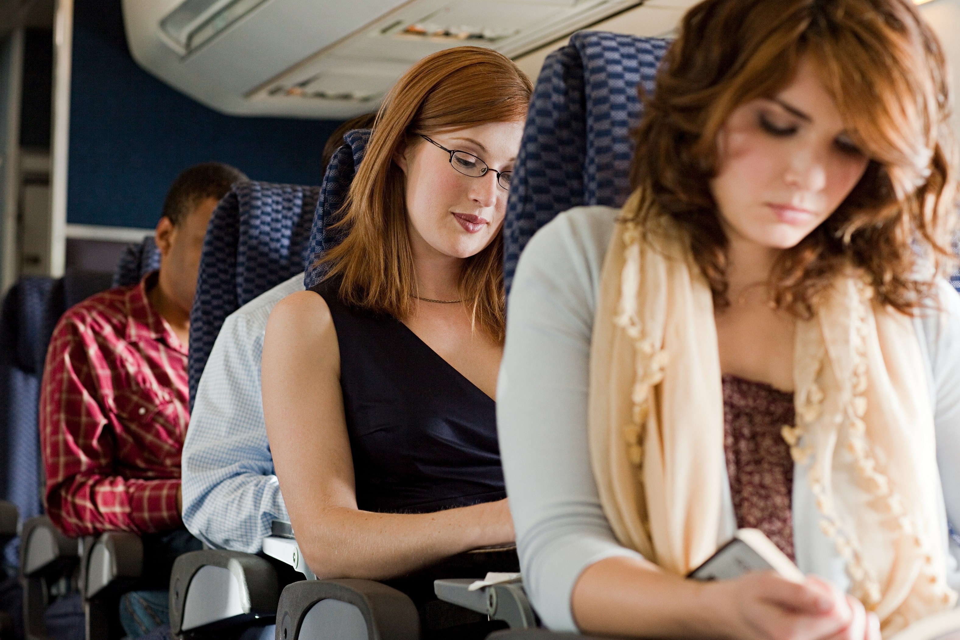 passengers reading on airplane