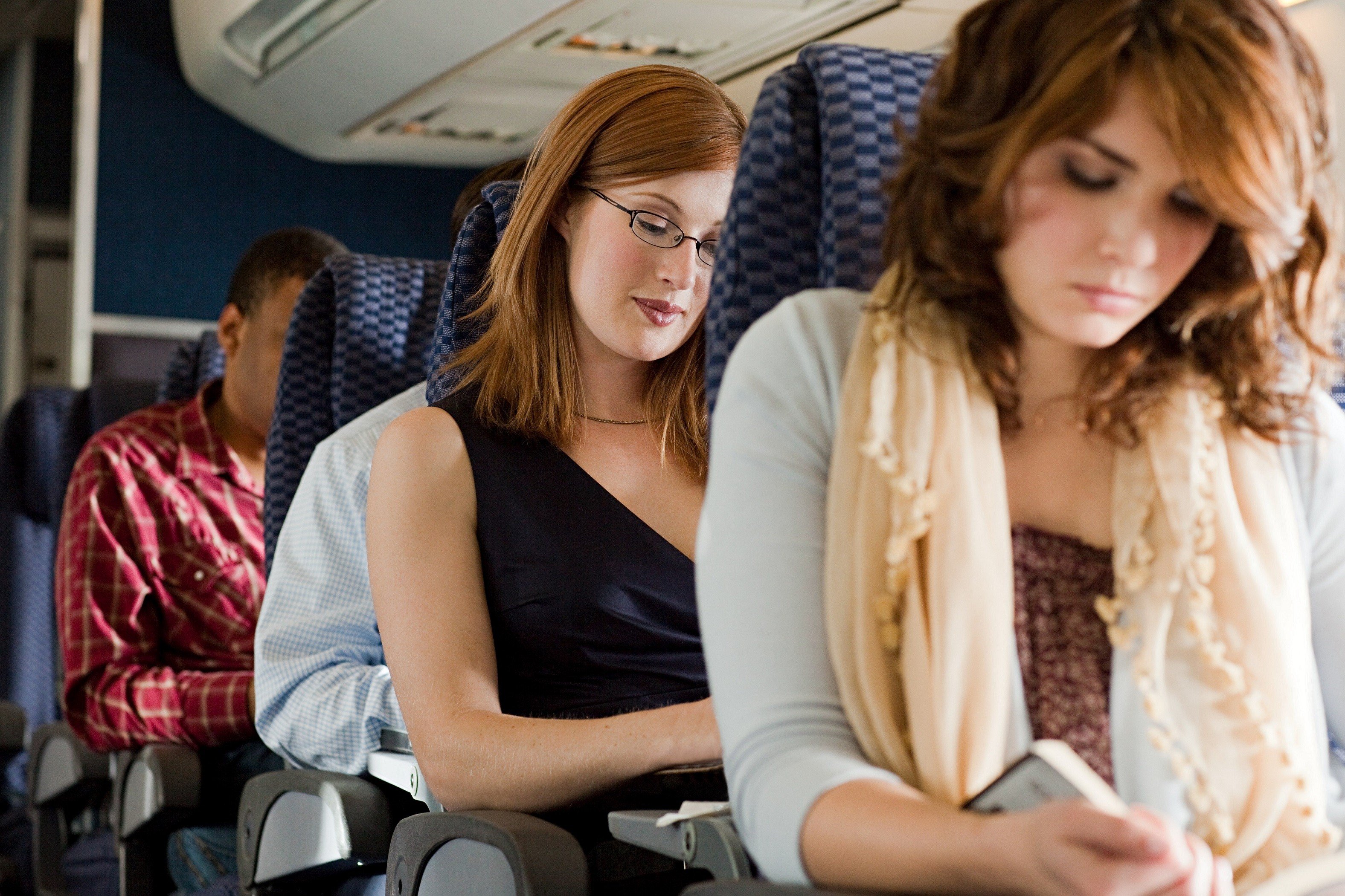 Women reading on airplane