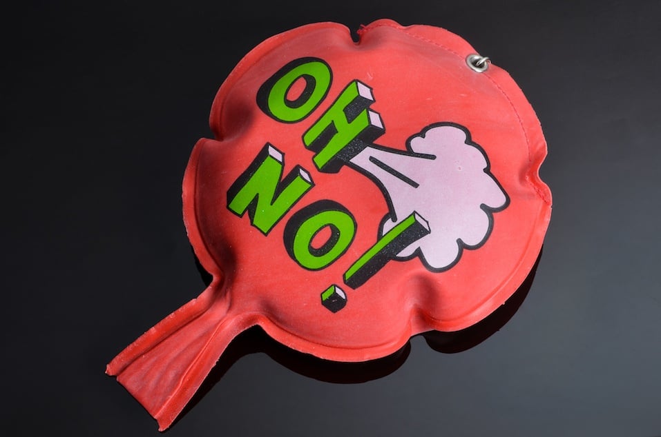 red rubber whoopee cushion with reflection on black glass red rubber whoopee cushion with reflection on black glass