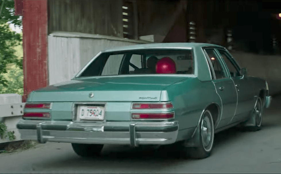 A red balloon is seen floating in the backseat of a car A red balloon is seen floating in the backseat of a car