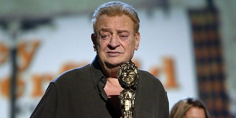 Rodney Dangerfield is on stage with an award. Rodney Dangerfield is on stage with an award.