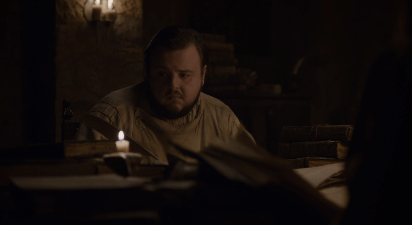 Looking disgruntled, Sam Tarley sits with a quill in his hand and stares at a book. Looking disgruntled, Sam Tarley sits with a quill in his hand and stares at a book.