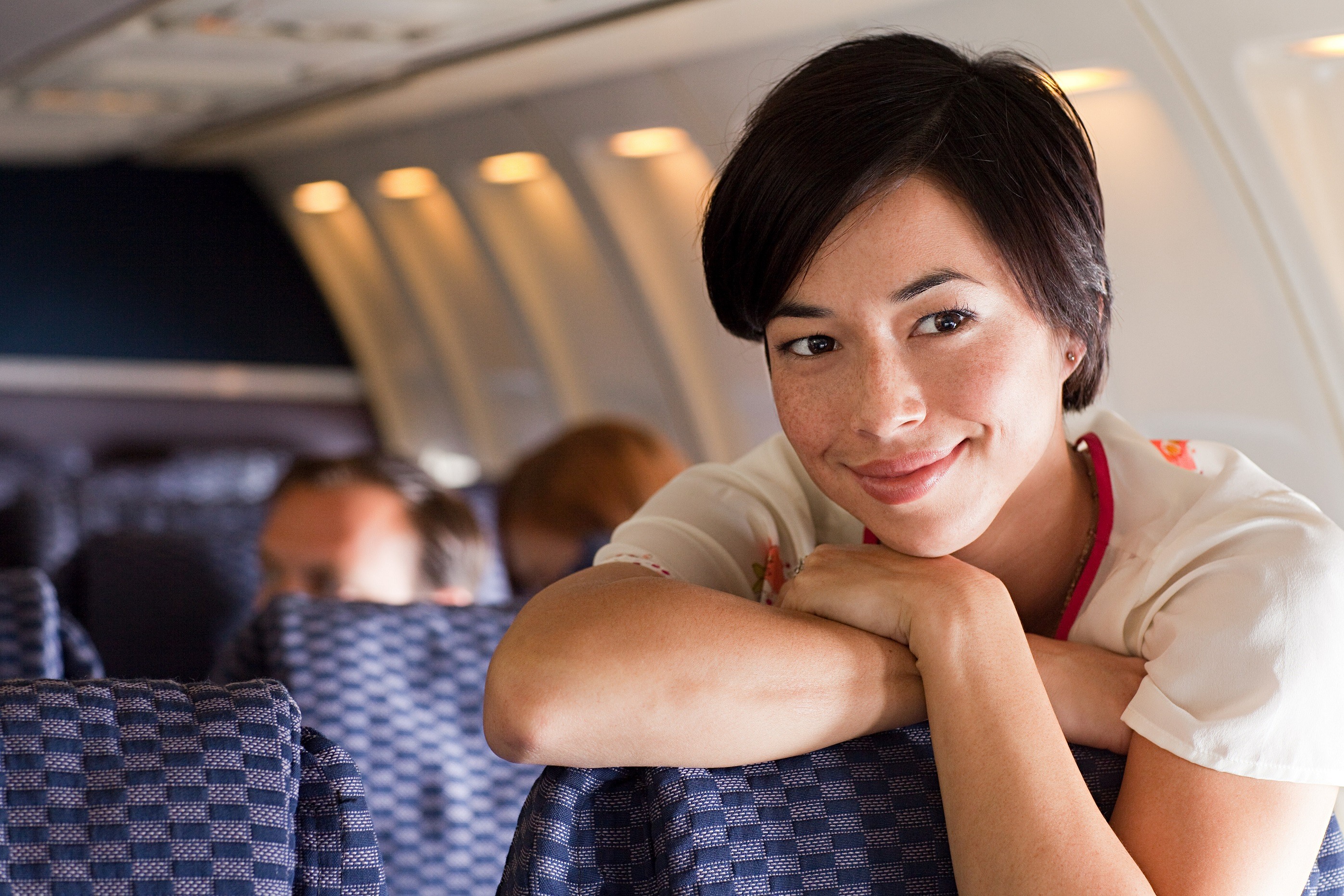 Young woman standing on an airplane