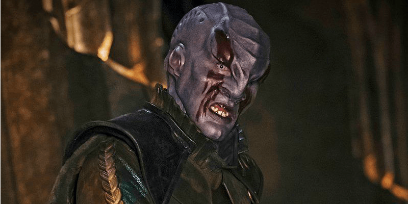 A purple Klingon looks into the camera. A purple Klingon looks into the camera.