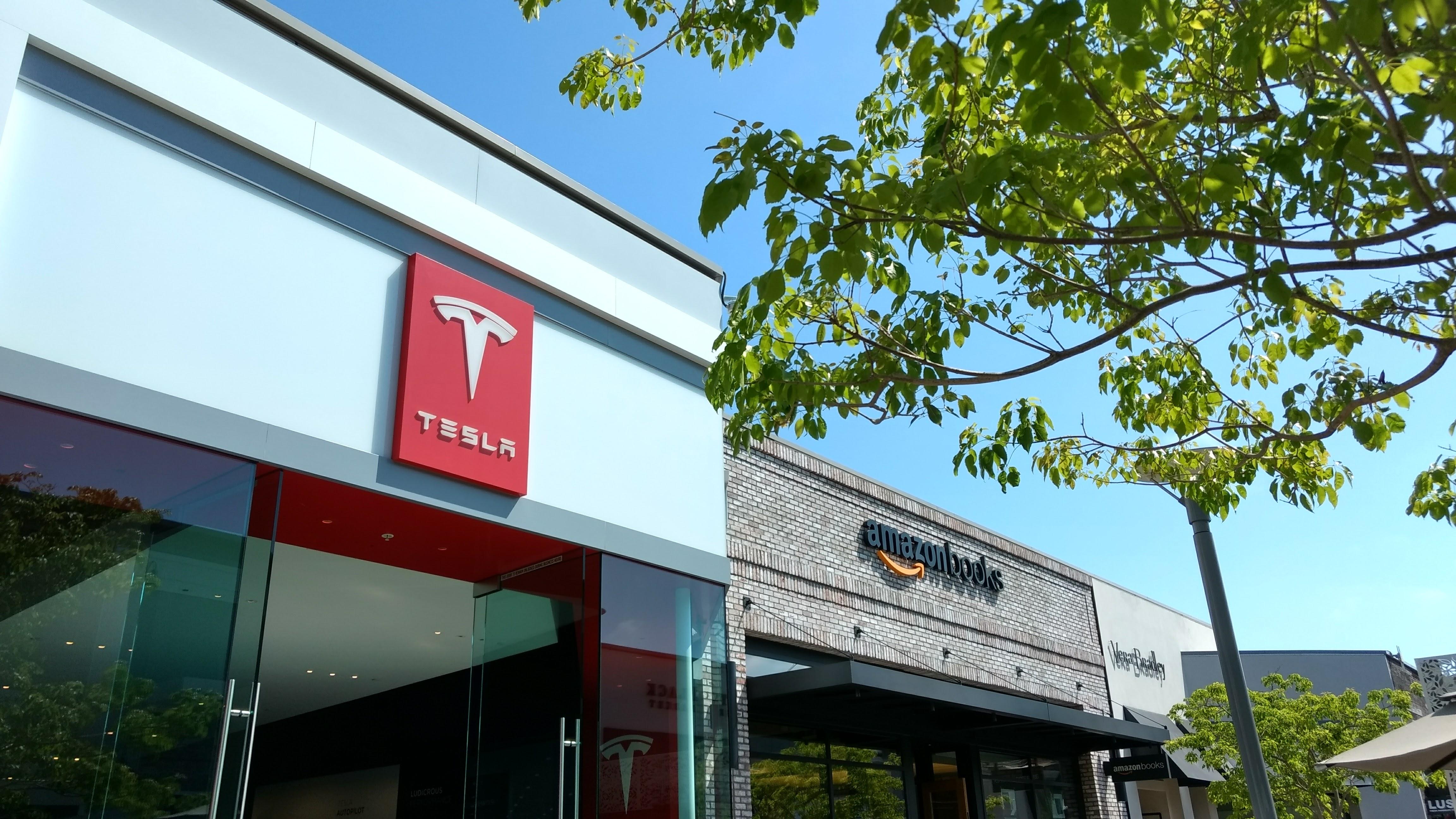 storefronts of Tesla showroom and Amazon bookstore
