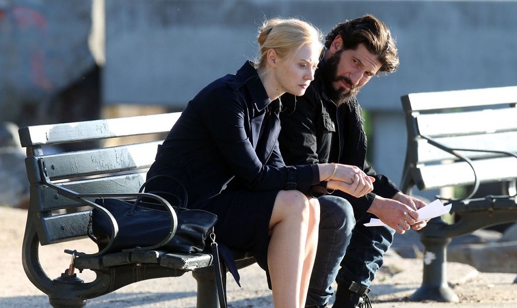 Deborah Ann Wolf and Jon Bernthal sitting on a bench in The Punisher