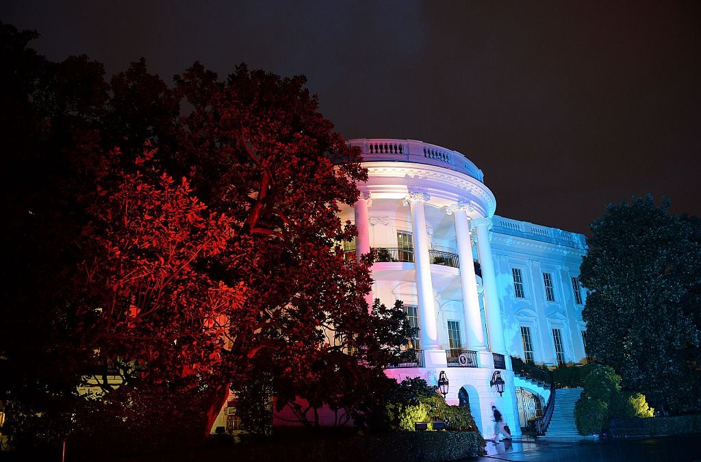 The White House illuminated in red, white and blue lights