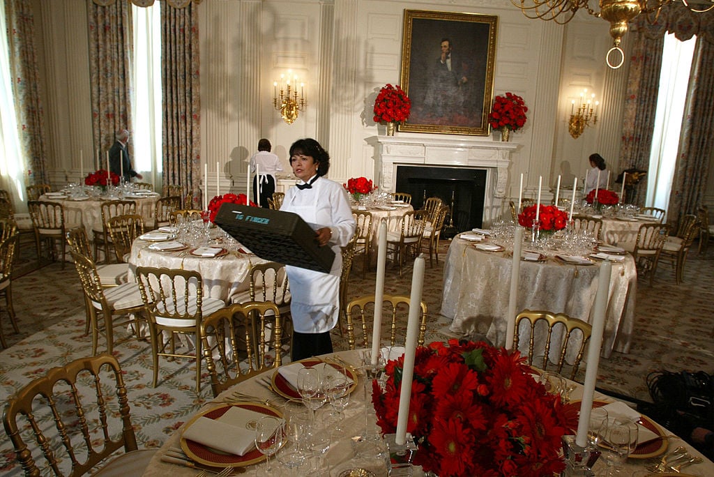 A kitchen staff member prepares the State Dining Room